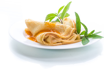 sweet thin pancakes with jam in a plate