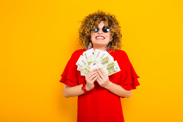 Attractive woman with short curly hair with cash