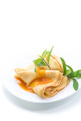 sweet thin pancakes with jam in a plate