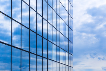 Clouds are reflected in a glass facade