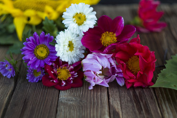Flowers frame on wooden background. Top view with copy space