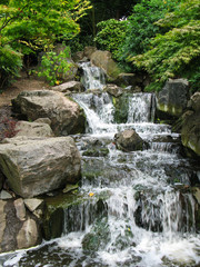 Fototapeta na wymiar Scenic cascade waterfall in Holland park in London, Great Britain .