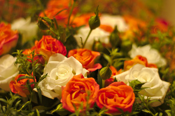 A bouquet of small white and orange roses