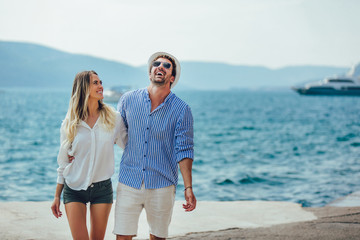 Couple in love, enjoying the summer time by the sea.