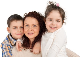 Happy Mother with daughter and son hugging on background