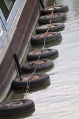 row of tyres along side the barge on the water ways 