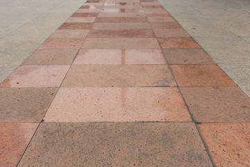 Marble walkway decorated with metal pillars in the middle way
