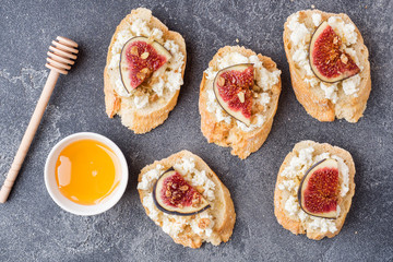 Snacks bruschetta with cottage cheese, walnut and honey and figs