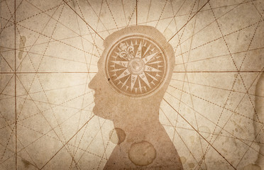 Fototapeta na wymiar Human head and compass. The concept on the topic of navigation, psychology, morality, etc.