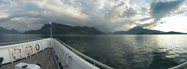 Sailing the Lake of Luzern/Switzerland with clouds over the Pilatus mountain