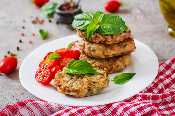 Spicy vegan burgers with rice, chickpeas and herbs. Salad tomato and basil. Vegetarian food.