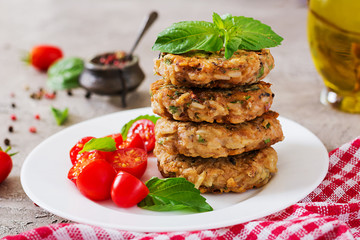 Spicy vegan burgers with rice, chickpeas and herbs. Salad tomato and basil. Vegetarian food.