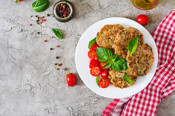 Spicy vegan burgers with rice, chickpeas and herbs. Salad tomato and basil. Vegetarian food. Top view. Flat lay