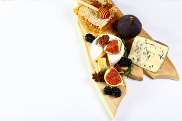 cheese board, cheese with blue mildew, Camembert or brie cheese circle with honey, figs, walnuts on wooden board, Isolated on white background, Flat lay, Copy space