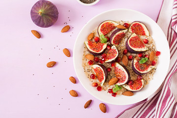 Delicious and healthy oatmeal with figs, almond and chia seeds. Healthy breakfast. Fitness food. Proper nutrition. Flat lay. Top view.