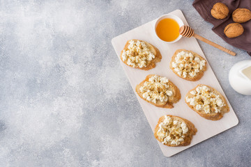Snack bruschetta with cottage cheese, walnut and honey. Top view