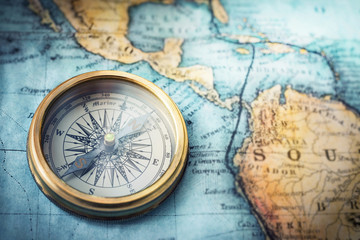 Fototapeta na wymiar Magnetic compass on world map.Travel, geography, navigation, tourism and exploration concept background. Macro photo. Very shallow focus.