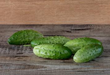 Fresh cucumbers on a wooden background