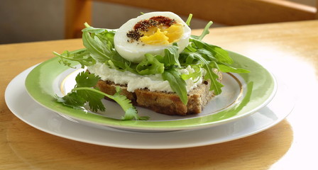 Toast with cream cheese, arugula and boiled egg, healthy breakfast