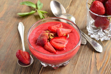 Strawberry milkshake with fresh berries and granola