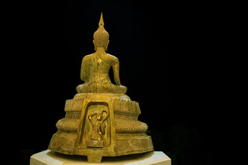 Golden Buddha statue on isolated black background