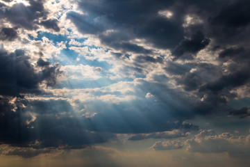 Dramatic cloudy sky with sun beams