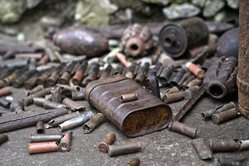 Military background with cartridges of grenades and machine-gun tape. Black archeology. World War II and its artifacts. Great Patriotic War of the USSR
