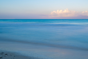 A calm beautiful morning on the beach as the sun rises in Negril, Jamaica