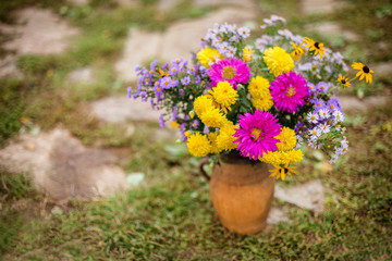 Autumn still life. bright autumn bouquet of flowers in a jug
