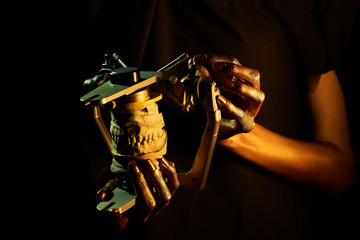 two golden hands with a dental instrument on a black background