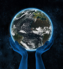 Guinea-Bissau on night planet Earth in hands