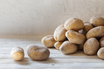 potatoes on background white old wall