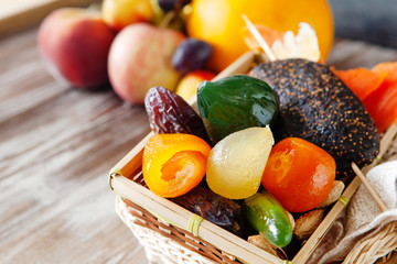 Mix of dried glazed fruits in syrup on wooden background