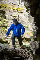 Obraz na płótnie Canvas A man hiking through crevice caves on the Niagara Escarpment.