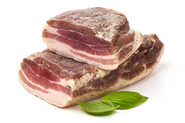 Smoked rustic farmer meat with basil leaves, isolated on white background.