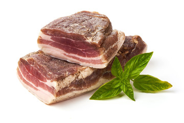 Smoked rustic farmer meat with basil leaves, isolated on white background.