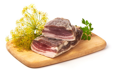 Smoked rustic farmer meat with parsley on a cutting board, isolated on white background.