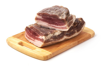 Smoked rustic farmer meat on a cutting board, isolated on white background.