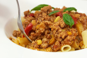 American food. Pasta alla genovese. Pasta with corn, fried meat and sauce.