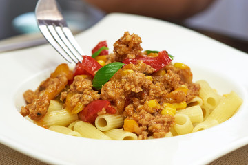 American food. Pasta alla genovese. Pasta with corn, fried meat and sauce.