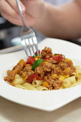 American food. Pasta alla genovese. Pasta with corn, fried meat and sauce.
