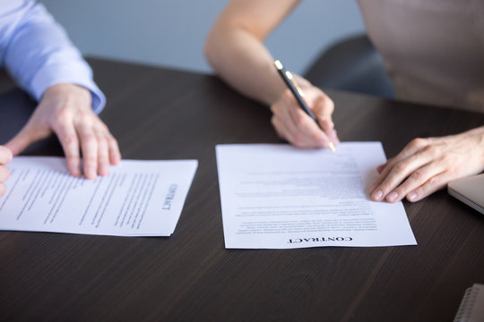 Close up of business partners sign cooperation contract during office corporate meeting, hired employee and ceo put signature on agreement after successful interview. Collaboration, employment concept