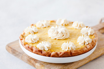 Traditional shortcrust pastry lemon tart with citrus custard and whipped cream