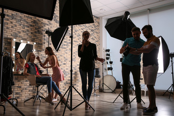 Professional team working with model in photo studio