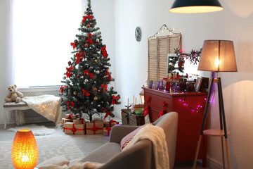 Stylish living room interior with decorated Christmas tree