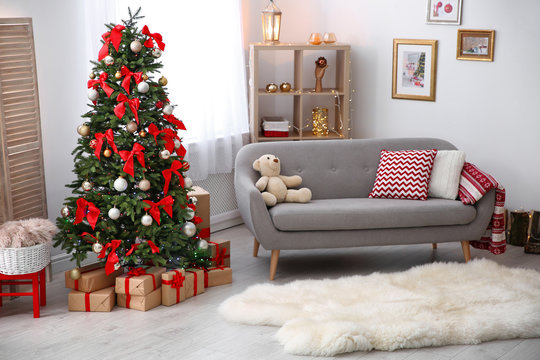 Room interior with beautiful Christmas tree and gifts