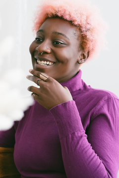 Smiling black woman with pink hair