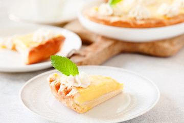 Traditional shortcrust pastry lemon tart with citrus custard and whipped cream