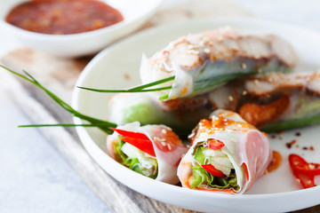 Fresh spicy vietnamese salad rolls with shrimp on a white plate