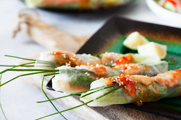 Fresh spicy vietnamese salad rolls with shrimp on a white plate